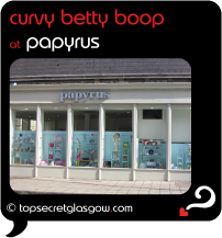 Top Secret Glasgow Quote Bubble showing sunny exterior of shop front.
Caption: curvy betty boop